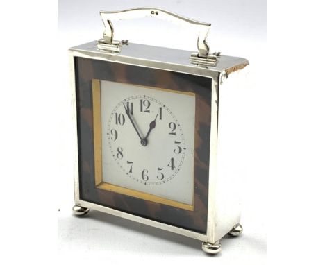 Silver cased mantle clock with white dial surrounded by tortoiseshell banding with loop handle and ball feet H10cm Birmingham