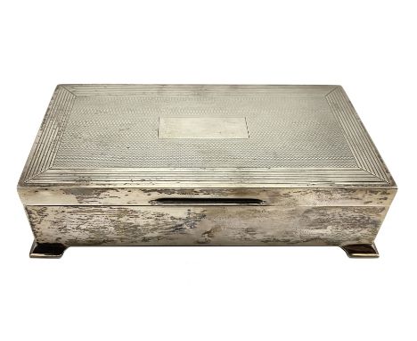 Silver rectangular cigarette box with engine turned cover and bracket feet L17cm Birmingham 1950 Maker Harman Bros.