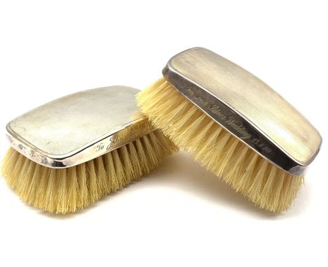 Pair of engine turned silver backed hairbrushes with inscription dated 1980