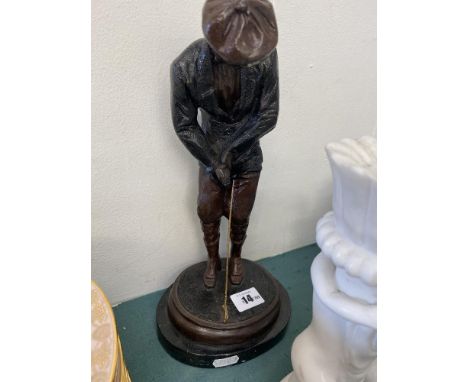 A bronze figure of a golfer