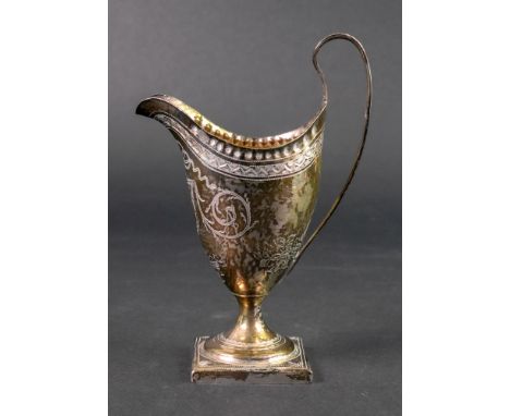 A George III silver helmet cream jug, London 1791, makers mark unclear, with punched rim, bright cut engraved with ribbon tie