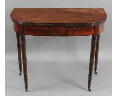 A Regency mahogany ebony banded tea table, the demi lune hinged fold over top with reeded edge, on ring turned legs, 91.5cm w