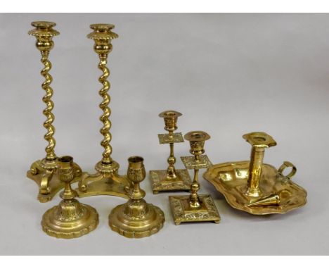 A pair of brass spiral column candlesticks, in late 17th century style, on scrolled tripod supports and concave sided bases, 
