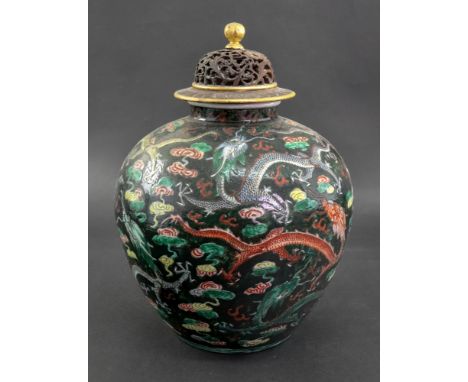 A Chinese famille noire oviform vase, 19th century, painted with dragons chasing flaming pearls amongst cloud scrolls against