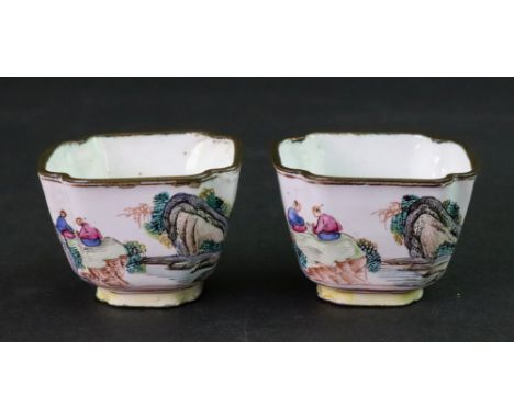 A pair of Canton enamel small cups, 19th century, each panted with two figures seated in a landscape, 3.5cm high (2).