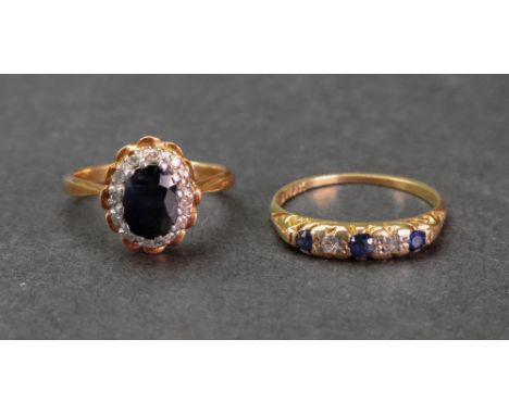 An 18ct gold and platinum five-stone sapphire and diamond ring, sing size O; and an 18ct gold sapphire and diamond oval clust