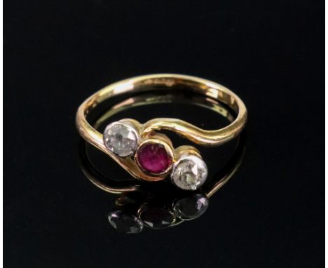 A 18ct gold, ruby and diamond three-stone cross-over ring, the central collet-set circular-cut ruby, between collet-set old m