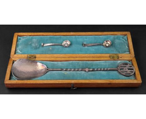 An Arts & Crafts hand wrought spoon, apparently unmarked, with a spot hammered pear shape bowl, the twisted stem with a squar