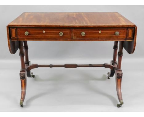 A Regency mahogany satinwood and tulipwood crossbanded boxwood and ebony strung sofa table, with rounded drop leaves above tw