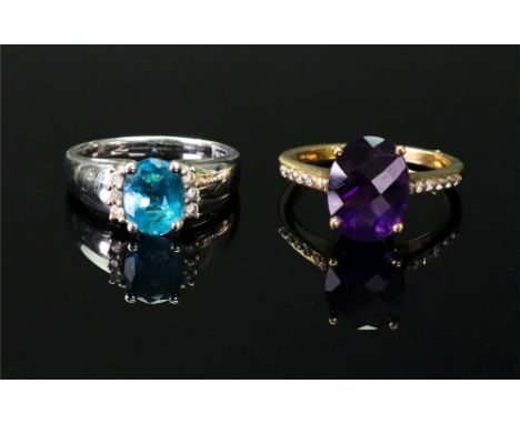 An 18ct gold, amethyst and diamond-set dress ring set with an oval mixed-cut amethyst four claw set, with circular-cut diamon