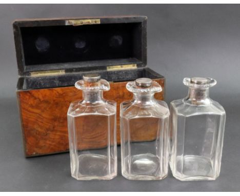 A Victorian brass bound figured walnut veneered rectangular decanter box, the hinged cover enclosing a fitted leather lined i