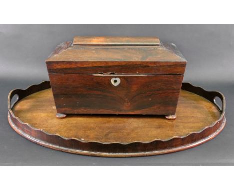 A William IV rosewood sarcophagus shape tea caddy, the hinged cover enclosing two lidded compartments flanking a recess for a