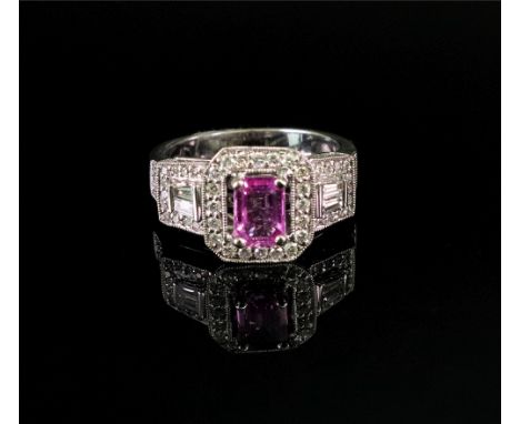 An 18ct white gold, pink sapphire and diamond-set dress ring, the central rectangular step-cut pink sapphire, claw-set in a s