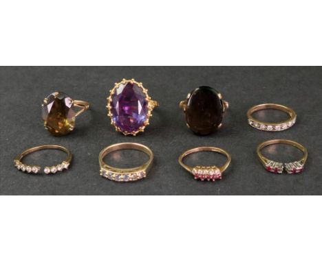 A collection of eight 9ct gold, diamond and gem-set dress rings, comprising: a diamond-set half hoop ring; a white stone set 