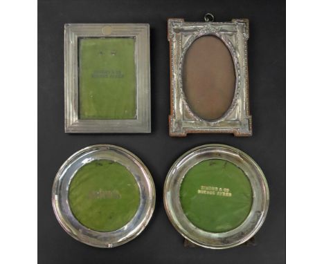 A rectangular engine turned silver mounted photograph frame, Birmingham 1917, a pair of silver mounted circular frames and a 