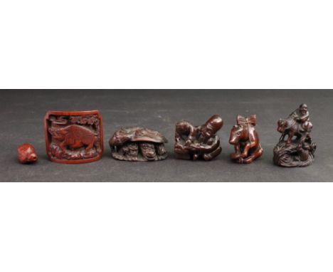 A group of six wooden netsuke to include; a figure riding a cow crossing a bridge, a reading lesson, a dragon hiding, signed,