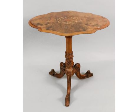 A Victorian walnut pedestal table, the figured walnut veneered top of serpentine outline and centred by boxwood leafy scrollw