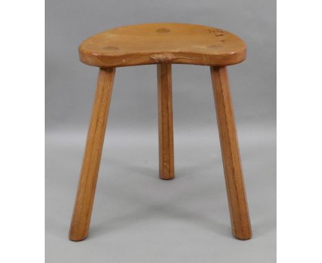 A Robert 'Mouseman' Thompson oak stool, the shaped top on three octagonal legs, with carved mouse, 36.5cm wide x 27cm deep x 