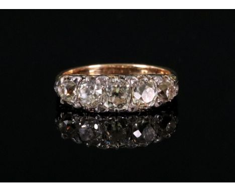 An 18ct gold five-stone diamond ring, the cushion-cut diamonds claw-set, set with rose-cut diamonds between, set in an openwo