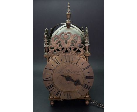 Thomas Moore Ipswich; a brass lantern clock, the square case with leafy scroll pierced and engraved crestings, the circular d