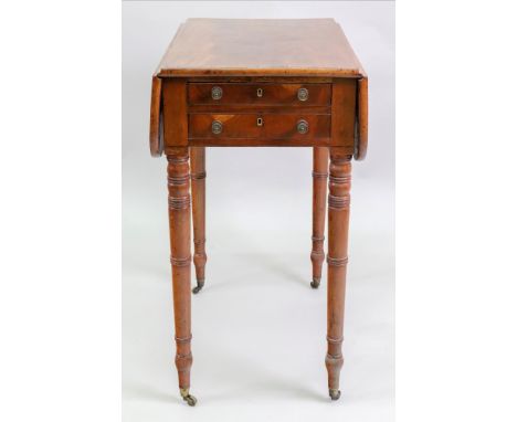 A Regency mahogany Pembroke table, with a rosewood crossbanded top above two drawers with opposing dummy drawers, on ring tur