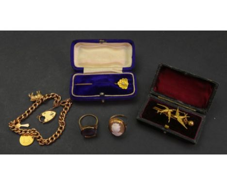 A 9ct gold charm bracelet, detailed '9c', hung with a 9ct gold heart shaped lock and a 9ct gold cross, both detailed '.375', 