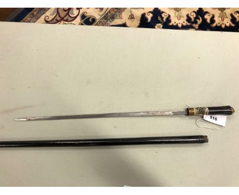 A SWORD STICK, THE EBONISED CANE WITH BRASS LION MASK POMMEL