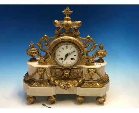 A FRENCH ORMOLU AND WHITE MARBLE CASED CLOCK WITH SWAGS BELOW THE ENAMEL DIAL AND URNS WITH FLAMBEAU FINIALS ABOVE AND BESIDE