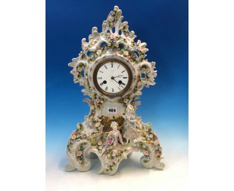 A PORCELAIN CASED BREGUET CLOCK STRIKING ON A BELL, THE ROCAILLE TOPPED CASE ENCRUSTED WITH FLOWERS, THE ENAMEL DIAL ABOVE A 