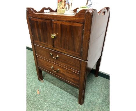A GEORGE III MAHOGANY NIGHT TABLE WITH HANDLES PIERCED INTO THE GALLERY OVER A CUPBOARD AND THE DRAW OUT COMMODE.   W 59 x D 