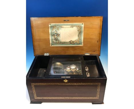 AN ANTIQUE MUSIC BOX PLAYING TEN AIRS ON A 14cms. COMB, DRUM AND THREE BELLS, THE CASE WITH PRINTED DECORATION. W 48cms.