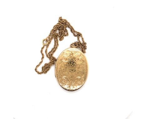 A ROPE TWIST CHAIN SUSPENDING AN OVAL PORTRAIT LOCKET WITH ENGRAVED DECORATION. THE CHAIN UNMARKED AND ASSESSED AS 9ct GOLD ,
