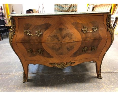 AN FRENCH STYLE WALNUT BOMBE COMMODE WITH GREEN VARIEGATED MARBLE TOP, FOLIATE ORMOLU MOUNTS FLANKING THE TWO DRAWERS AND RUN