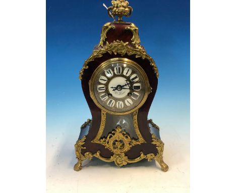 A HENRY MARC CLOCK IN AN ORMOLU MOUNTED TORTOISESHELL BALLOON SHAPED CASE SURMOUNTED BY A TWO HANDLED BOWL OF FLOWERS, THE MO