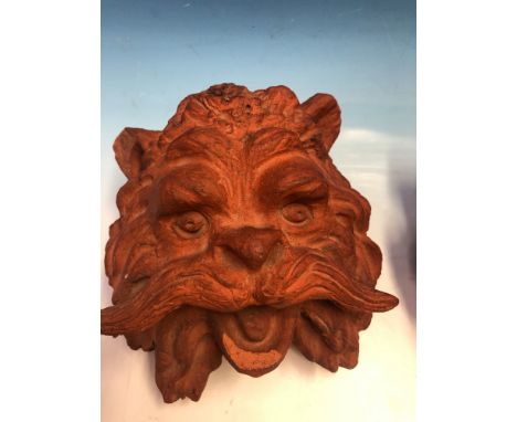 A PAIR OF TERRACOTTA WALL MOUNTING CAT MASKS, THE TOPS OF THEIR HEADS PIERCED TO TAKE A LAMP SOCKET.   H 15cms.