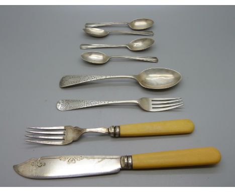 A silver fork and matching spoon, four silver spoons and a fish knife and fork with silver ferrules, 87g 