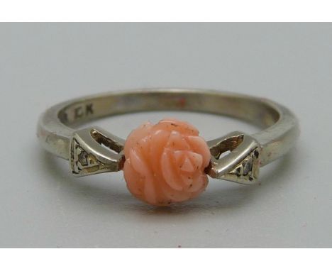 A 10ct white gold and carved coral ring with diamond accents, 2g, K 