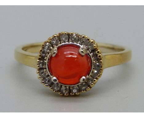 A silver gilt, orange stone ring with zircon halo, O 