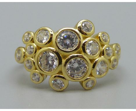 A silver gilt and white stone ring, U 