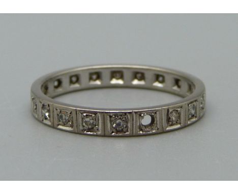 A white metal and diamond eternity ring, 2.9g, Q, lacking two stones 