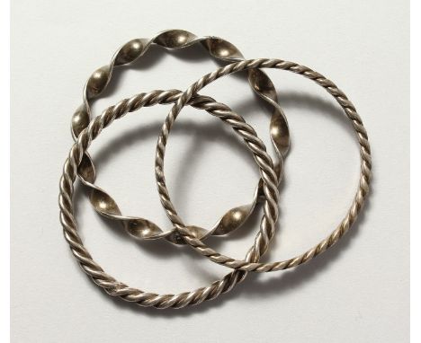THREE ISLAMIC SILVER METAL BANGLES.