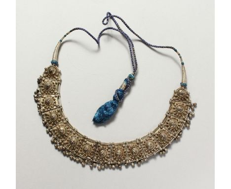 AN ISLAMIC SILVER METAL NECKLACE.