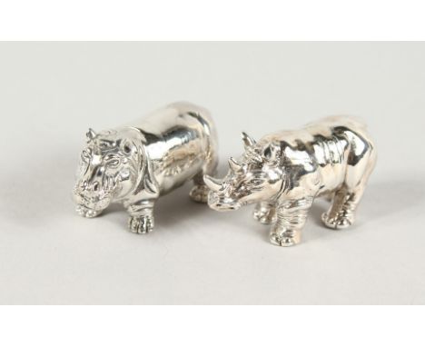 TWO CAST SILVER HIPPO AND RHINO FIGURES.