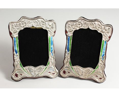 A PAIR OF SILVER AND BLUE ENAMEL BUTTERFLY PHOTOGRAPH FRAMES. 8ins x 5ins.