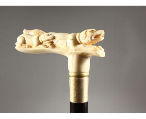 A CARVED BONE HANDLED WALKING STICK, DOG.