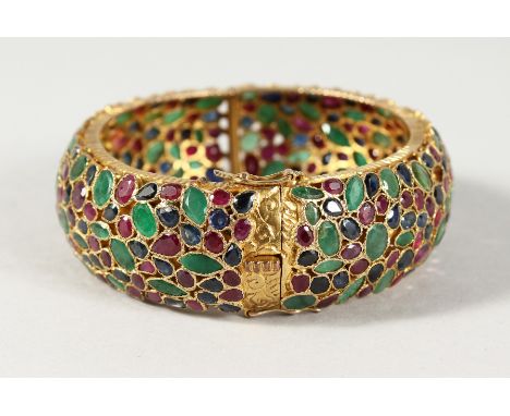 A SUPERB 18CT GOLD, EMERALD, RUBY AND SAPPHIRE BANGLE. 54gms.