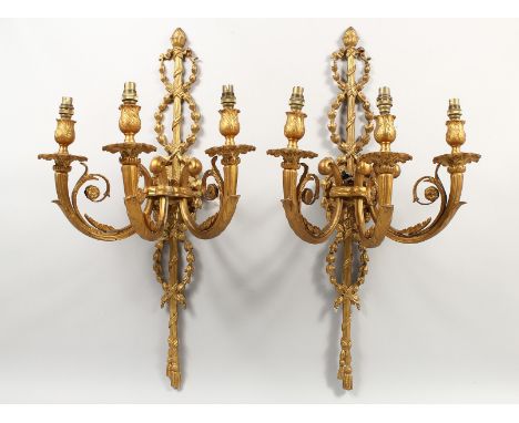 A PAR OF CAST METAL THREE LIGHT CLASSICAL STYLE WALL APPLIQUES. 27.5ins high.