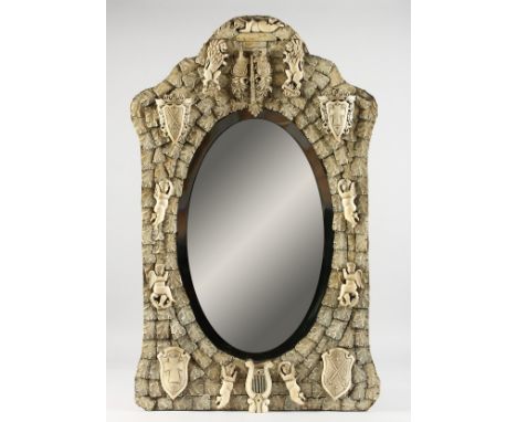A GOOD DIEPPE PRISONER OF WAR CARVED BONE MIRROR, CIRCA. 1860, with emblems, shields, etc., with oval mirrored panel. 32ins h