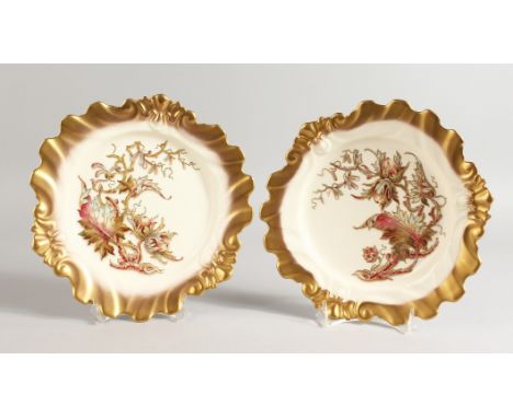 A ROYAL WORCESTER PAIR OF PLATES of silver shape, each decorated with enamels and raised gilding with hazelnuts, strawberries