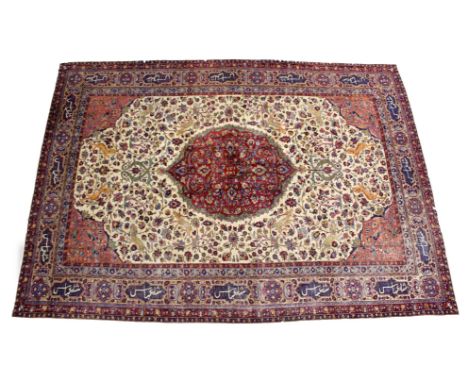 A GOOD PERSIAN CARPET, cream ground with central floral decorated crimson ground panel, the main body of the carpet decorated